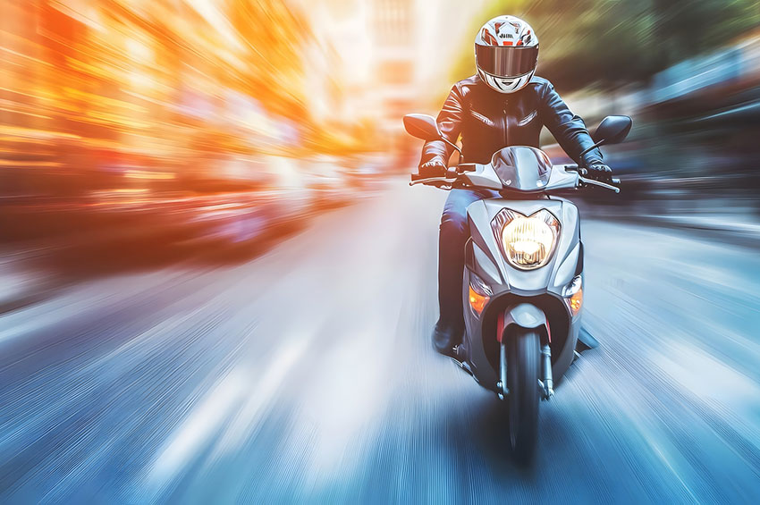 Motorcycle rider speeding through city traffic illustrating the risks of hit-and-run crashes